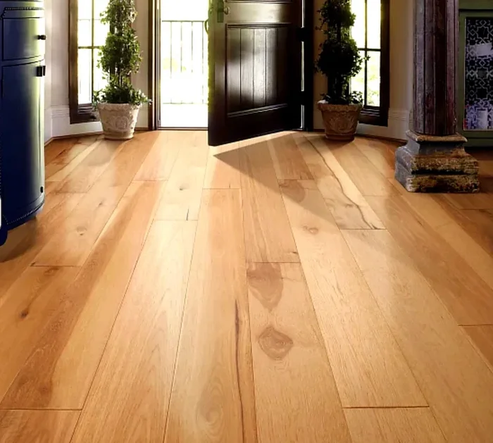 Hickory planks run through a mountain-lodge dining hall, bold color variation and rustic strength complementing exposed log beams and wrought-iron chandeliers.