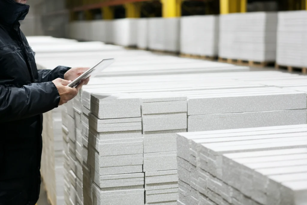 Pallet of premium porcelain tile being loaded onto a delivery truck at sunrise
